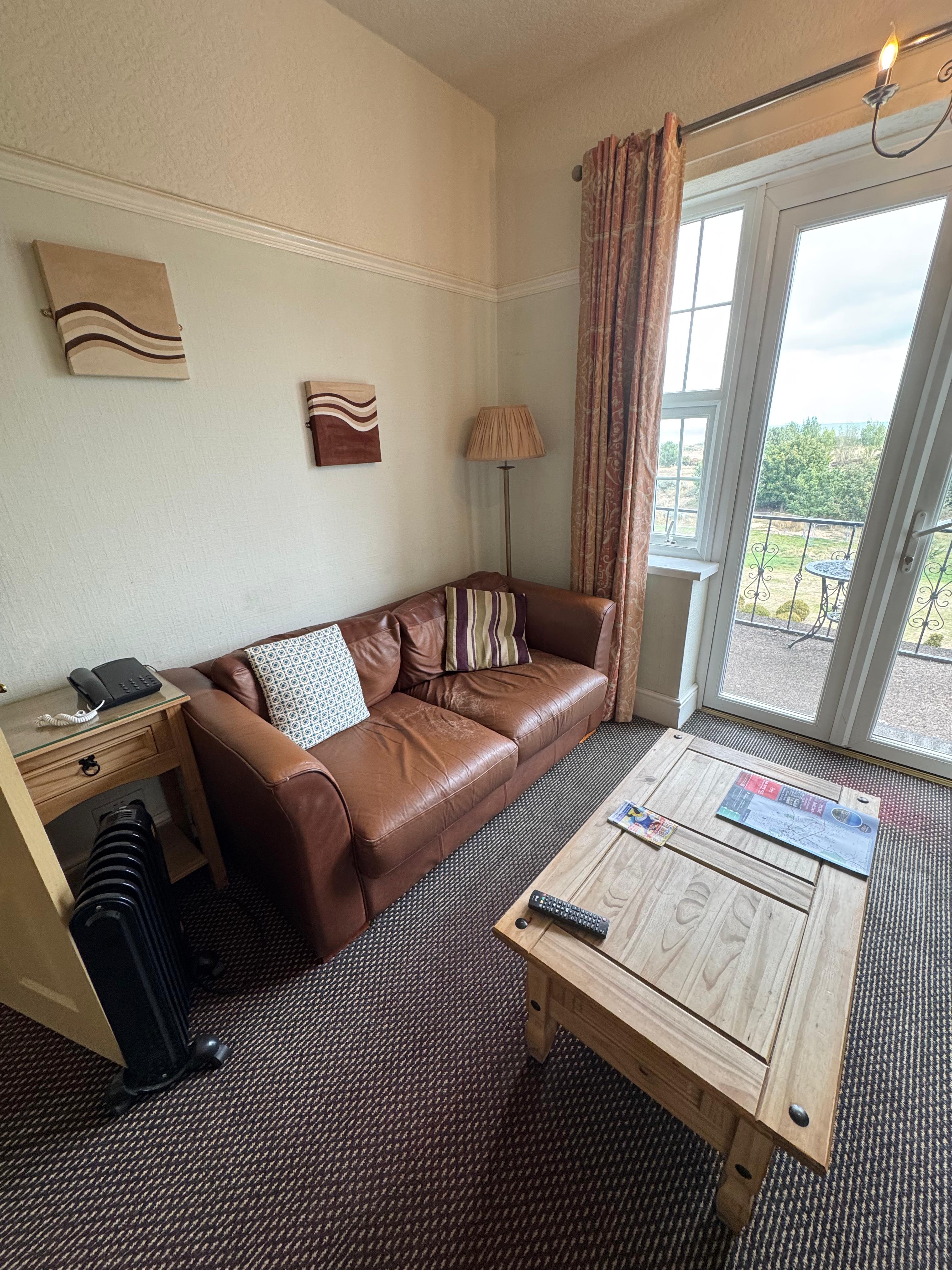Executive Suite — four-poster bed with sea view